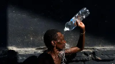 Homem se refresca com garrafa de água no Rio de Janeiro 