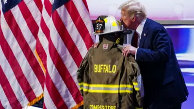 Republican presidential nominee and former President Donald J. Trump kisses the uniform of Corey Comperatore, the retired firefighter killed in the assassination attempt, delivers remarks during the final day of the Republican National Convention (RNC) at the Fiserv Forum in Milwaukee, Wisconsin, USA, 18 July 2024. The convention comes just a few days after a 20-year-old Pennsylvania man attempted to assassinate former President and current Republican presidential nominee Donald Trump. The RNC is being held 15 to 18 July 2024 and is where delegates from the Republican Party select their nominees for president and vice president in the 2024 US presidential election.