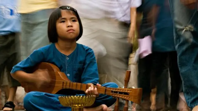 Criança tocando instrumento musical