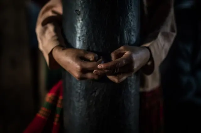 A pair of hands around a pipe