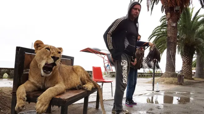 A man and his lion, at the Black Sea, Abkhazia