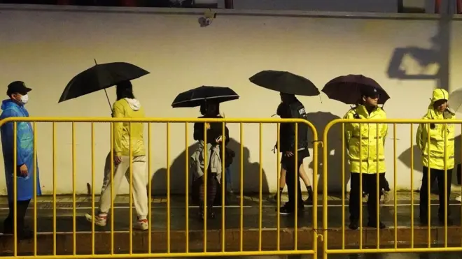 Police officers keep watch near barricades set up along Julu Road where people in Halloween costumes gathered the year before, in Shanghai, China October 26, 2024.