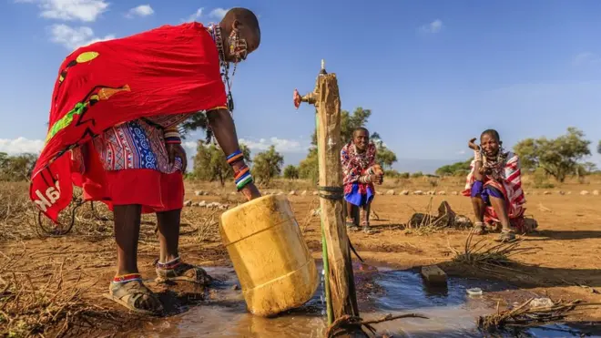 A woman from the Maasai tribe collects water in Kenya