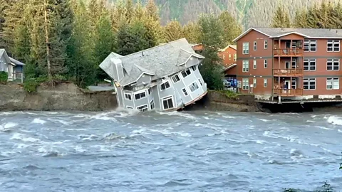 A home falling into water