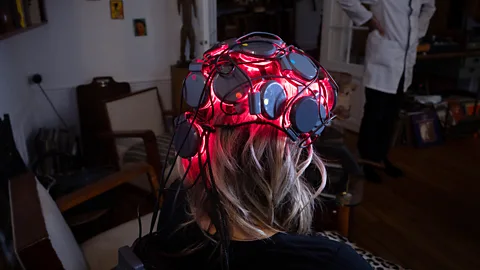 A researcher adjusting an EEG cap on the head of former NHL player Bryan Muir (Credit: Getty Images)