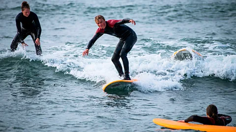 Surfers on Denmark's north-west coast (Credit: Getty Images)