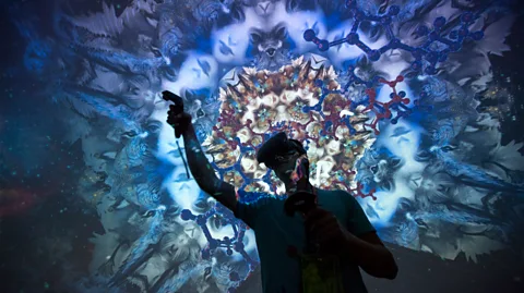 Getty Images Man wearing virtual reality headset amidst tessellated blue projection (Credit: Getty Images)