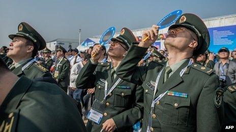 Officers of China's People Liberation Army (PLA) watch planes performing during the 9th China International Aviation and Aerospace Exhibition in Zhuhai, 13 November 2012