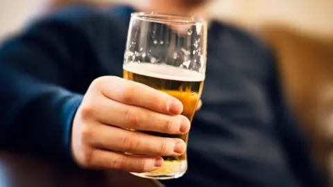 Man holding a pint glass