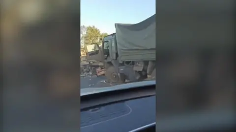 Destroyed truck in video taken from mobile phone on another vehicle