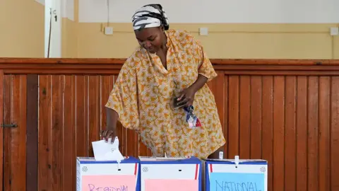 A woman casts her vote in the South African 2024 election