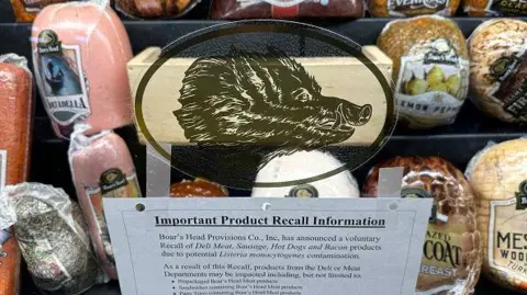 Display of Boar's Head deli meats with a recall notice posted