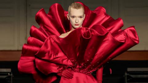 a model wearing a big red frilly dress