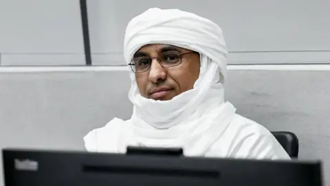 AFP Al Hassan Ag Abdoul Aziz Ag Mohamed Ag Mahmoud sitting in the ICC courtroom