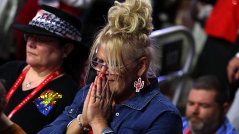 Woman prays at the RNC