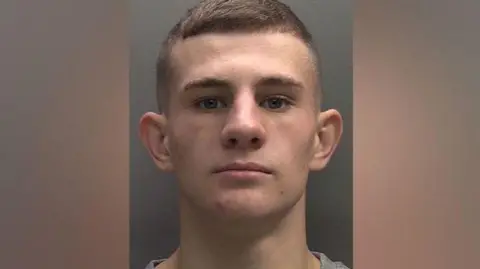 Police mugshot of Connor Hulse with short brown hair