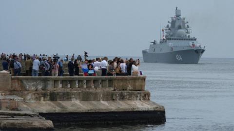 People watch Russia's frigate Admiral Gorshkov as it enters the Havana Bay, Cuba. Photo: 12 June 2024