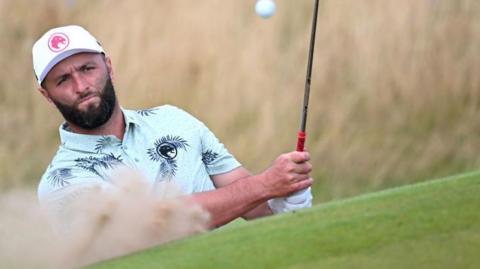 Jon Rahm playing a bunker shot during practice at Royal Troon