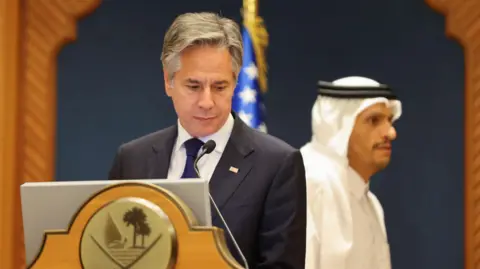 US Secretary of State Antony Blinken looks down ahead of a news conference with Qatar's Prime Minister, Sheikh Mohammed bin Abdul Rahman Al Thani, in Doha, Qatar (12 June 2024)