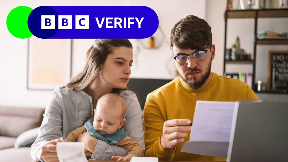 Getty Images Parents with an infant looking at paperwork
