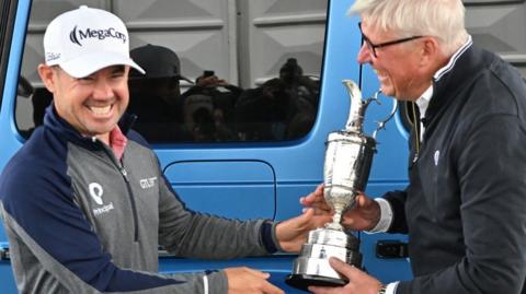 Brian Harman giving the Claret Jug back to R&A chief executive Martin Slumbers