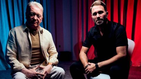 Frank Warren and Eddie Hearn sit down beside each other looking into camera