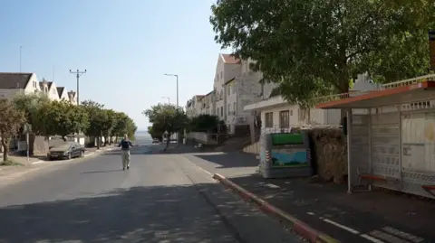 Paul Adams stands in a deserted street 