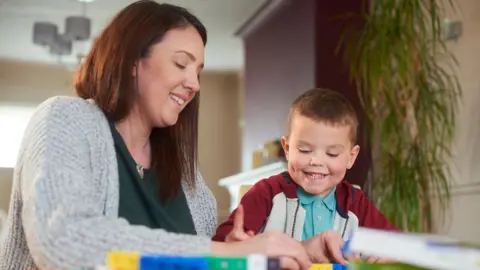 woman playing with child 