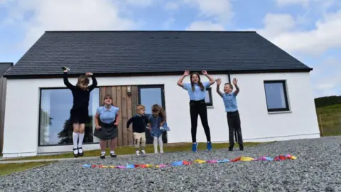 Children outside new home at Kilbeg