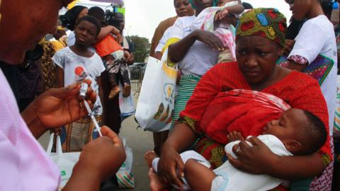 A child is inoculated with malaria vaccine during the launch of the vaccination campaign for children 