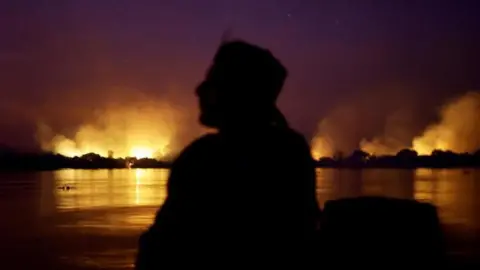 moke from the fire rises into the air as trees burn amongst vegetation in the Pantanal, the world's largest wetland, in Corumba, Mato Grosso do Sul state, Brazil, June 9, 2024.