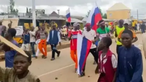 Protesters waving Russian flags in Zamfara state