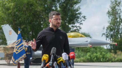 President Zelensky at a ceremony at a secret location, flanked by the jets