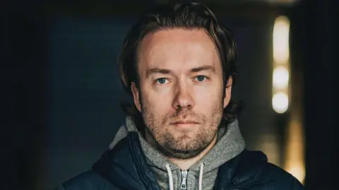 David Heinemeier Hansson co-owner of software firm 37signalswearing a hoodie and coat