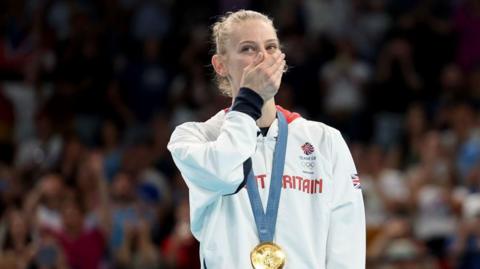 Bryony Page looks shocked by her gold