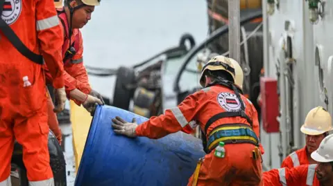 Getty Images Crew of a private company loads a barrel of oil spill dispersant to be used in the oil spill response,