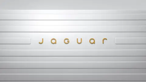 The new Jaguar logo in gold lettering, placed on a white background.