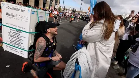 Fridge-wearing runner proposes to his girlfriend