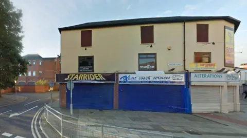 The building earmarked for apartments, with Grimsby Crown Court in the background