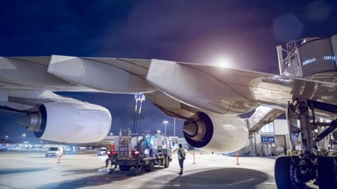 Airplane being refuelled - stock photo