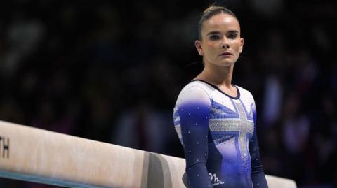 Alice Kinsella stands next to the beam