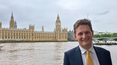 David Chadwick with Westminster in the background across the river.