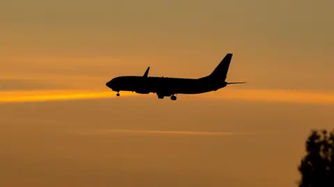 Silhouette of commercial airplane in the sky