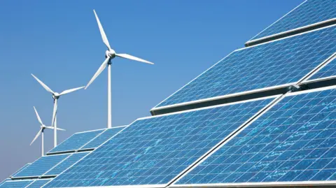 Three wind turbines and several solar panels against a blue sky