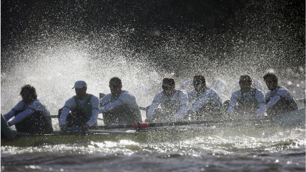 Cambridge rowing boat with water splashing up