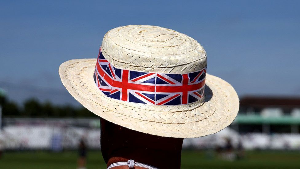 A cricket fan wears a Union flag-themed hat to shelter from the sun and the hot weather at Trent Bridge in Nottingham on 19 July 2024