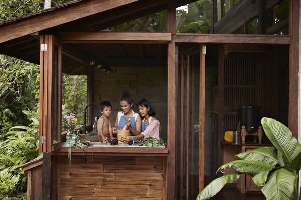 Family preparing food in kitchen at resort