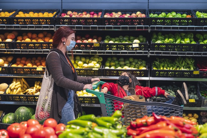 Asian Woman With Her Daughter Shopping In Supermarket With Face Protective Mask.