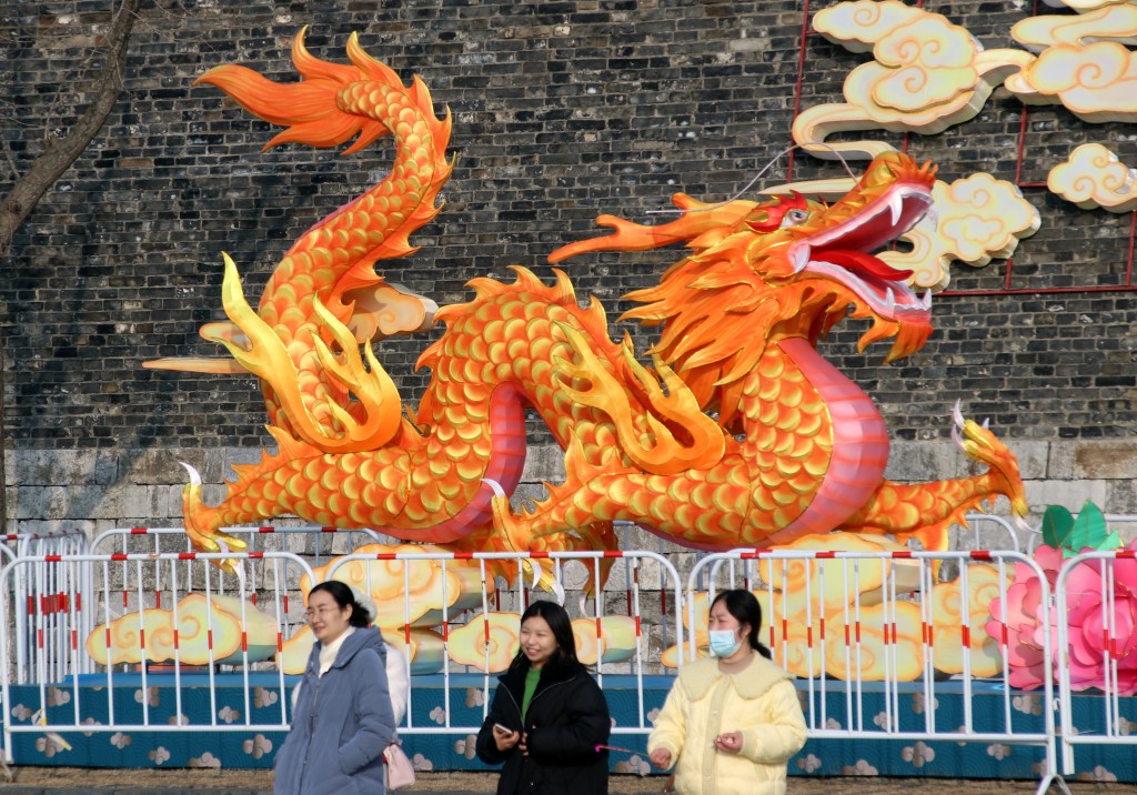 大除夕，遊客在江蘇省蘇州市姑蘇區街頭的龍年綵燈旁遊覽。  新華社