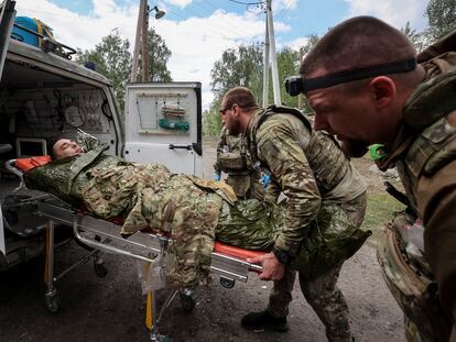 Personal sanitario atiende a un militar ucraniano herido, cerca de la ciudad de Vovchansk, en la región de Járkov, este domingo.